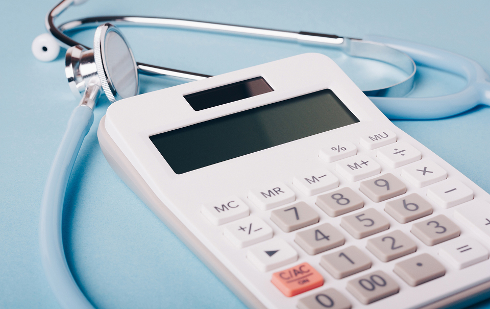 A stethoscope and calculator symbolizing medical reimbursement strategy and pricing analysis